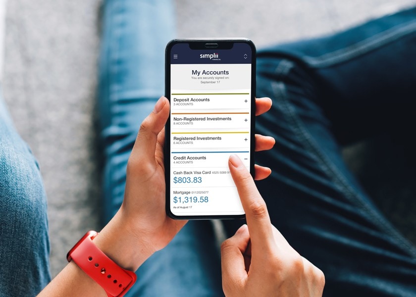 A woman checks her Simplii mortgage on her smartphone.