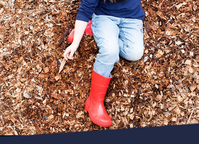 Girl sitting on the ground outside