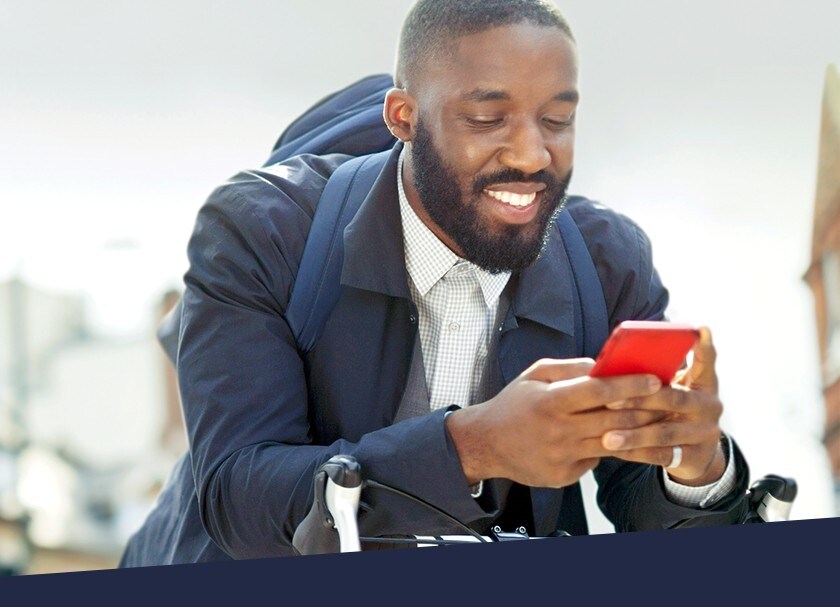 Man in suit sending a Global Money Transfer with his smartphone