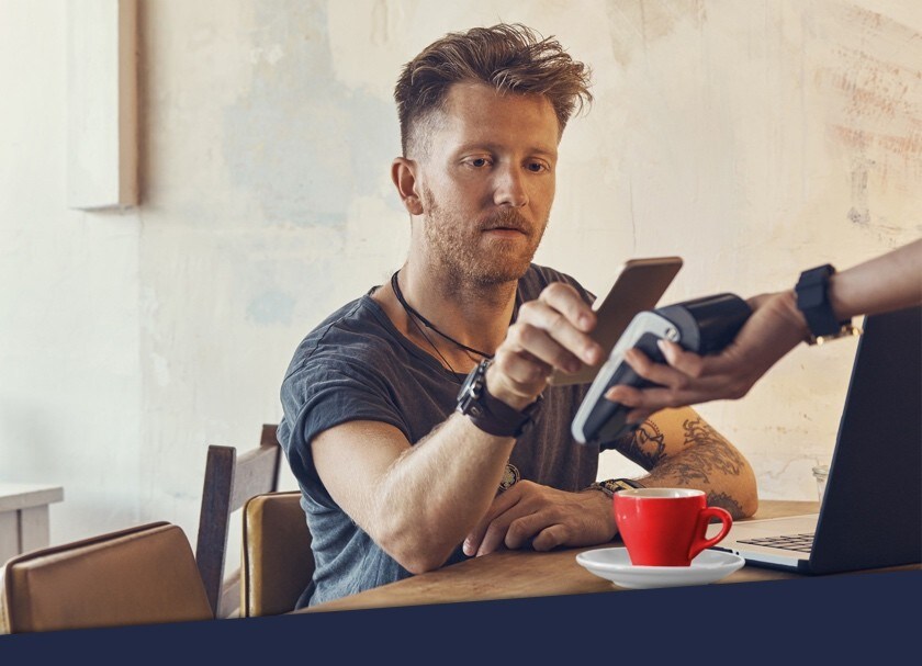 Man pays for coffee using mobile payment