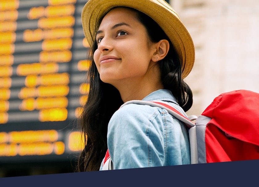 Woman in front of train schedule