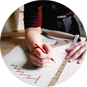 A person marks up a blueprint