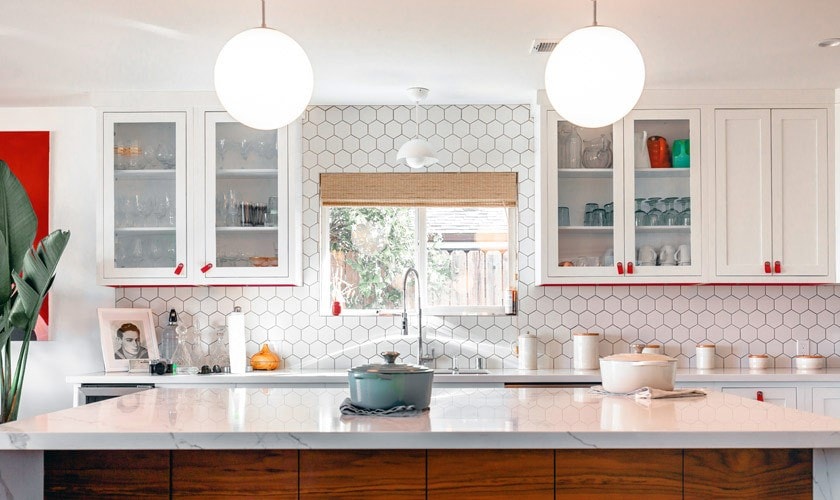 A bright kitchen with cabinets and a window
